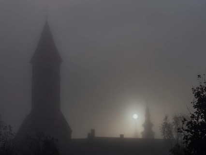 Church tower in the morning mist