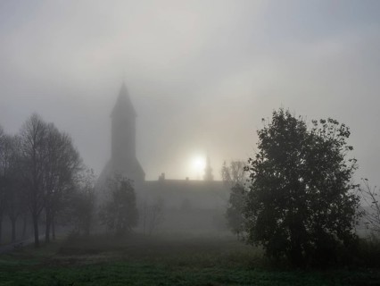Church tower in the morning mist