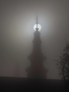 Church tower in the morning mist