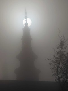 Church tower in the morning mist