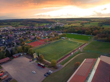 Football pitch in small village at sunset