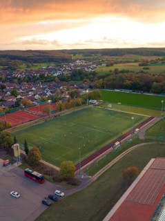 Football pitch in small village at sunset