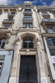 Artfully designed entrance with atlases of a historic residence