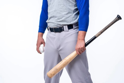 Baseball player holding bat ball