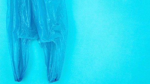 Clear disposable plastic bag blue background