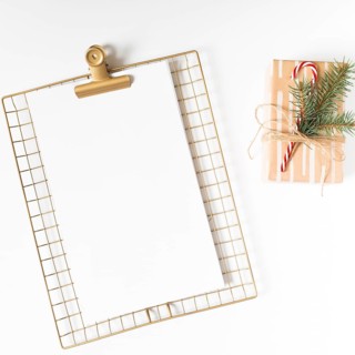 Clipboard with gift box white table