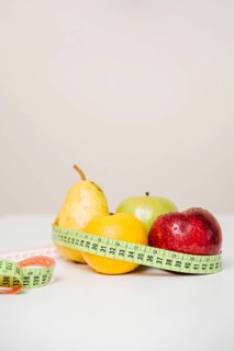 Close up fresh fruits with measuring tape table