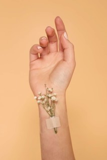 Close up hand with band aid flowers