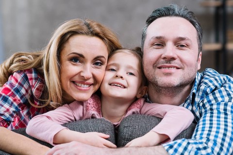 Close up happy family looking camera