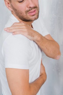 Close up man having pain his shoulder