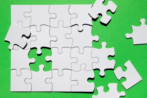 Close up puzzle piece green background