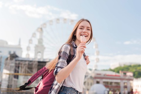 Close up woman holding popsicle icecream smiling