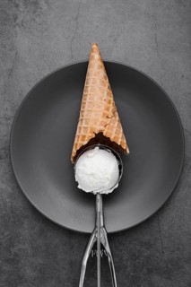 Cone with vanilla ice cream scoop
