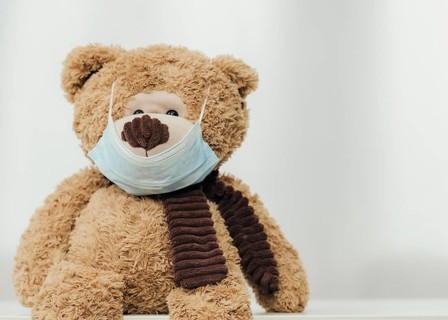 Cute teddy bear wearing medical mask