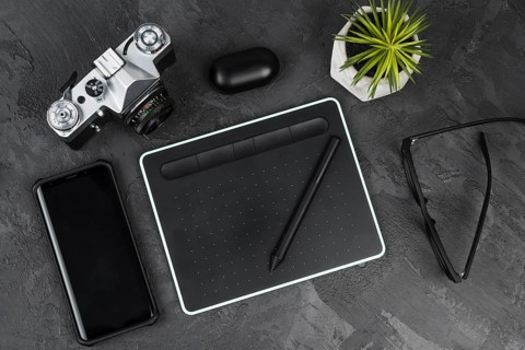 Desk arrangement slate background top view