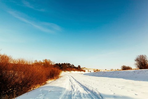 Diminishing perspective ski track snowy landscape against blue sky