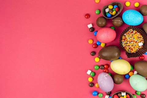 Easter eggs with chocolate eggs candies table