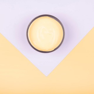 Elevated view yellow paint container dual paper background