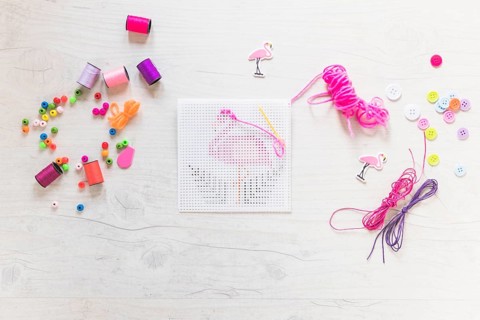 Embroidery cross stitch with floss thread decorative elements textured backdrop