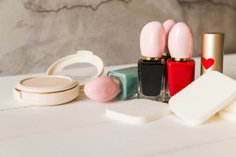 Face cosmetic compact makeup powder with sponges nail polish bottle lipstick table