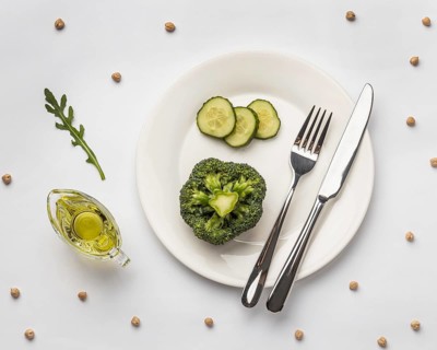 Flat lay fresh broccoli plate with cutlery