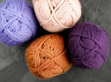 Flat lay orange purple wool yarn