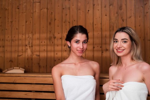 Friends posing relaxed sauna