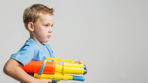 Front view child holding water gun