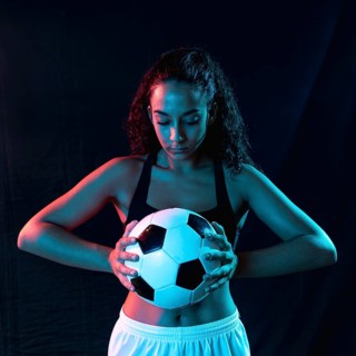 Front view fit woman with soccer ball