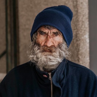 Front view homeless man with beard outdoors