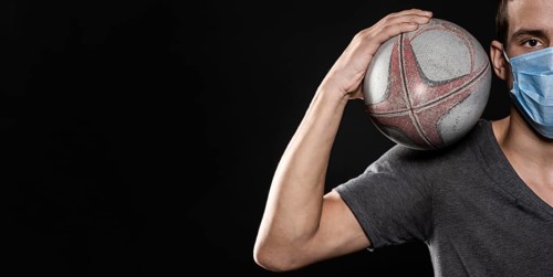 Front view male rugby player with medical mask ball