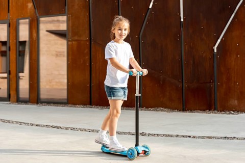 Girl white t shirt riding blue scooter