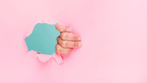 Hand through paper hole