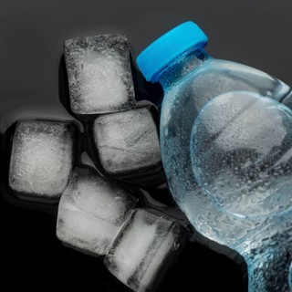 Ice cubes bottle water top view