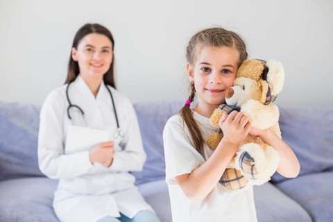 Ill girl being examined by doctor