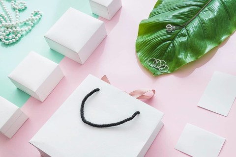 Jewelry with white boxes leaf paper backdrop