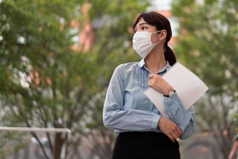 Low angle woman with face mask concept