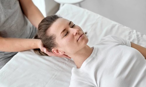 Male therapist undergoing physical therapy with female patient