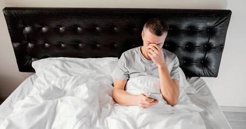 Man bed using mobile
