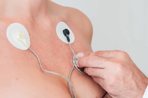 Man hand with stethoscope checking respiration woman