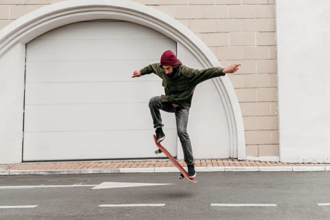 Man outdoors with skateboard city