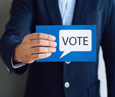 Medium shot man showing voting card with speech bubble