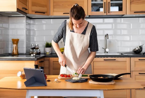 Medium shot woman cooking home