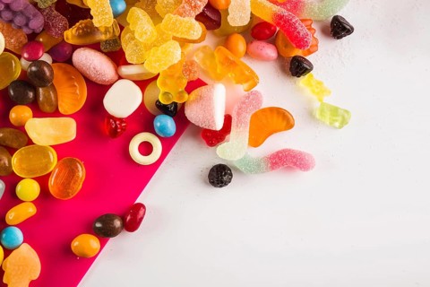 Multicolored winegums white fuchsia background