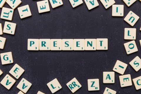 Overhead view present text scrabble letters black backdrop