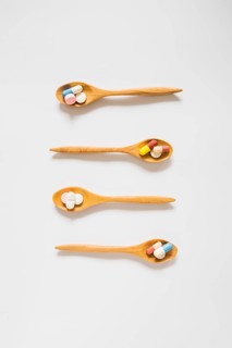 Overhead view wooden spoons with pills
