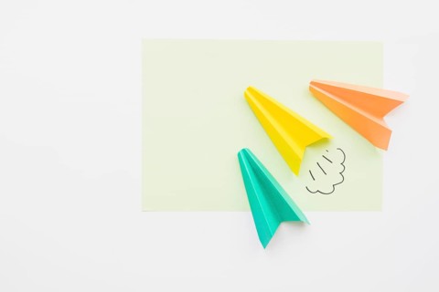 Paper planes flying diagonally