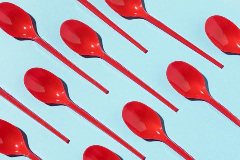 Red plastic spoons top view