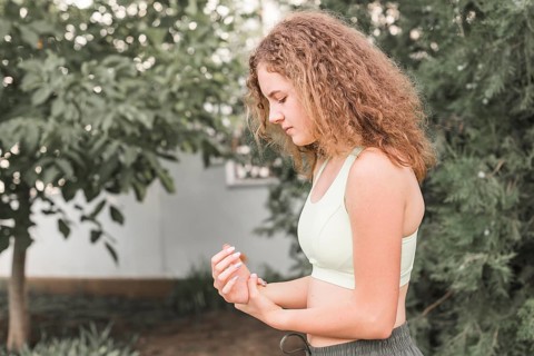 Side view female athlete having wrist pain