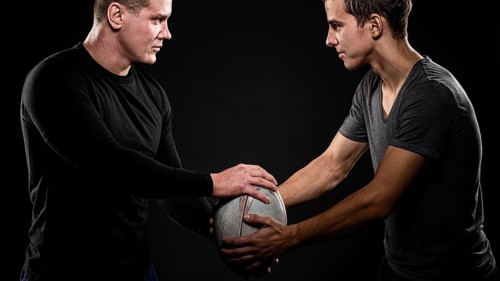 Side view male rugby players holding ball